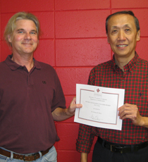 Donald Davis with Keng Deng receiving his certificate