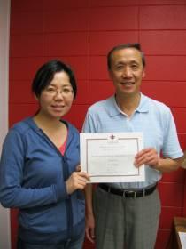 Wang Qian with Keng Deng receiving his certificate